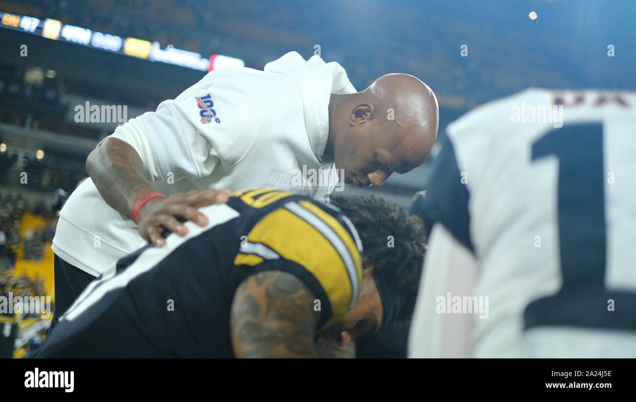 Pittsburgh Steelers quarterback Ben Roethlisberger (7) walks off the field  holding the jersey of linebacker Ryan Shazier after beating the Baltimore  Ravens 39-38 to clinch the AFC North Championship in an NFL