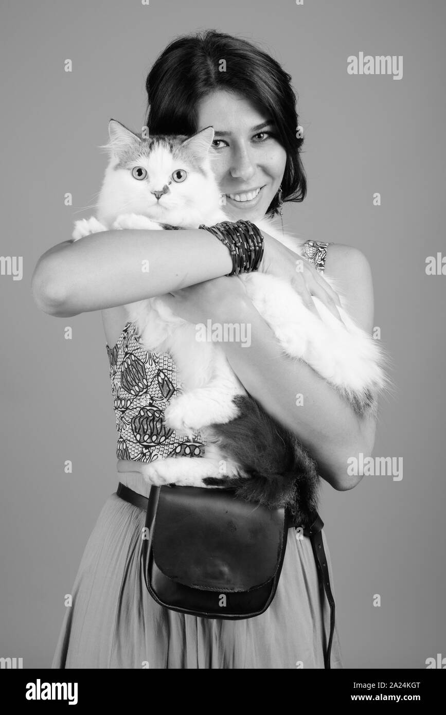 Young beautiful woman with Persian cat shot in black and white Stock Photo