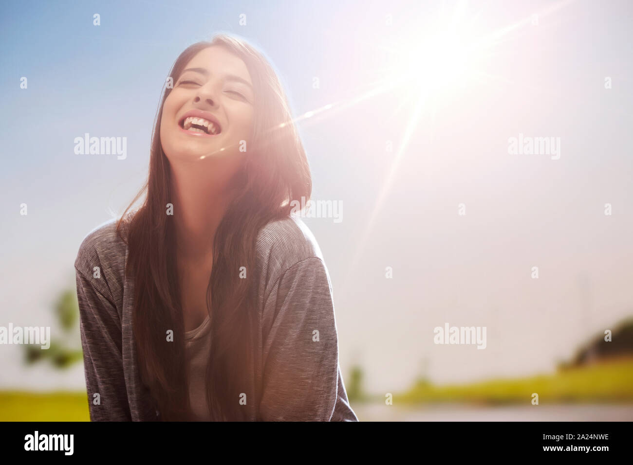 Close up portrait of a smiling teenage girl standing outdoors with her ...