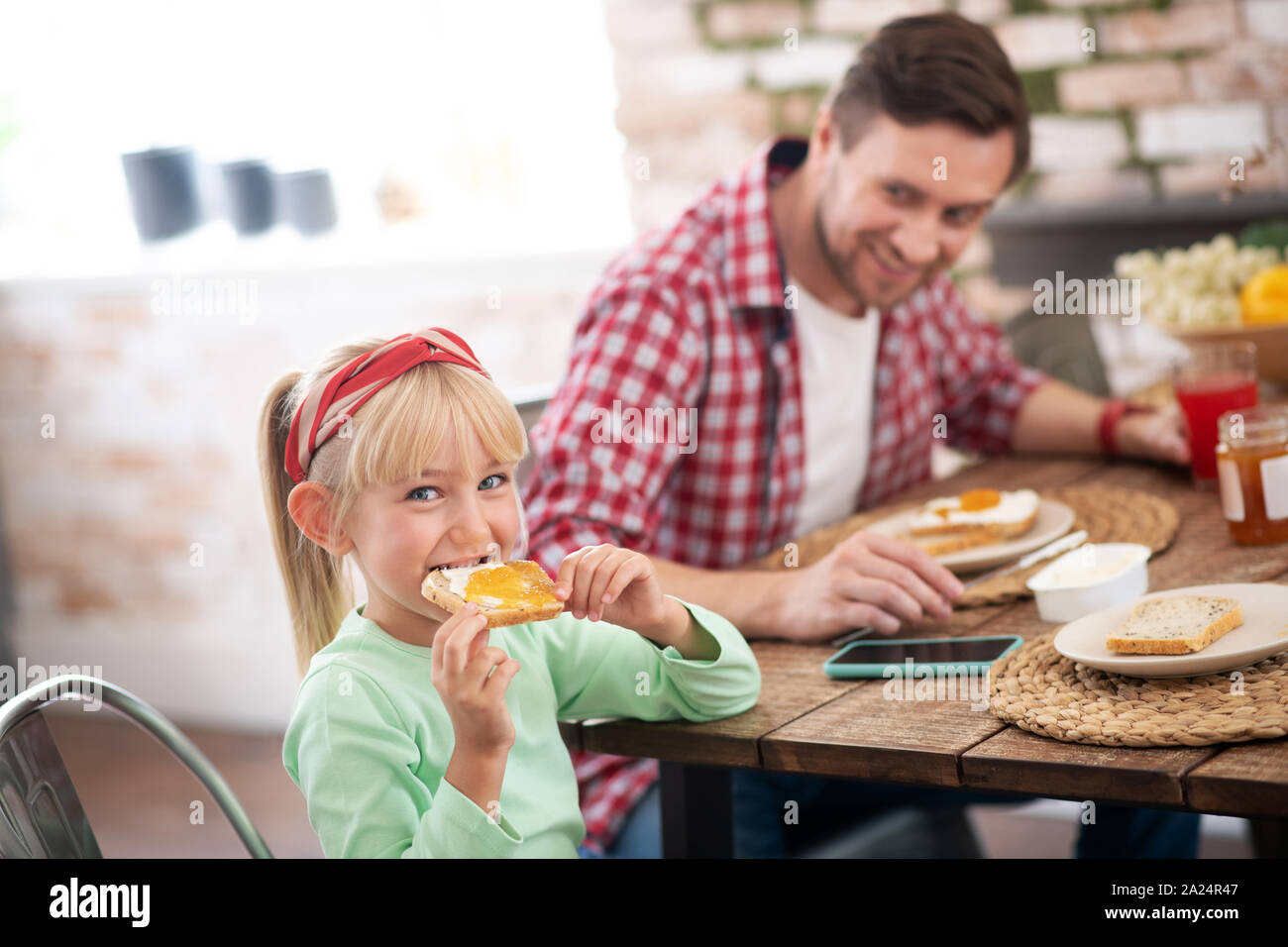 Girl eating toast breakfast hi-res stock photography and images - Alamy