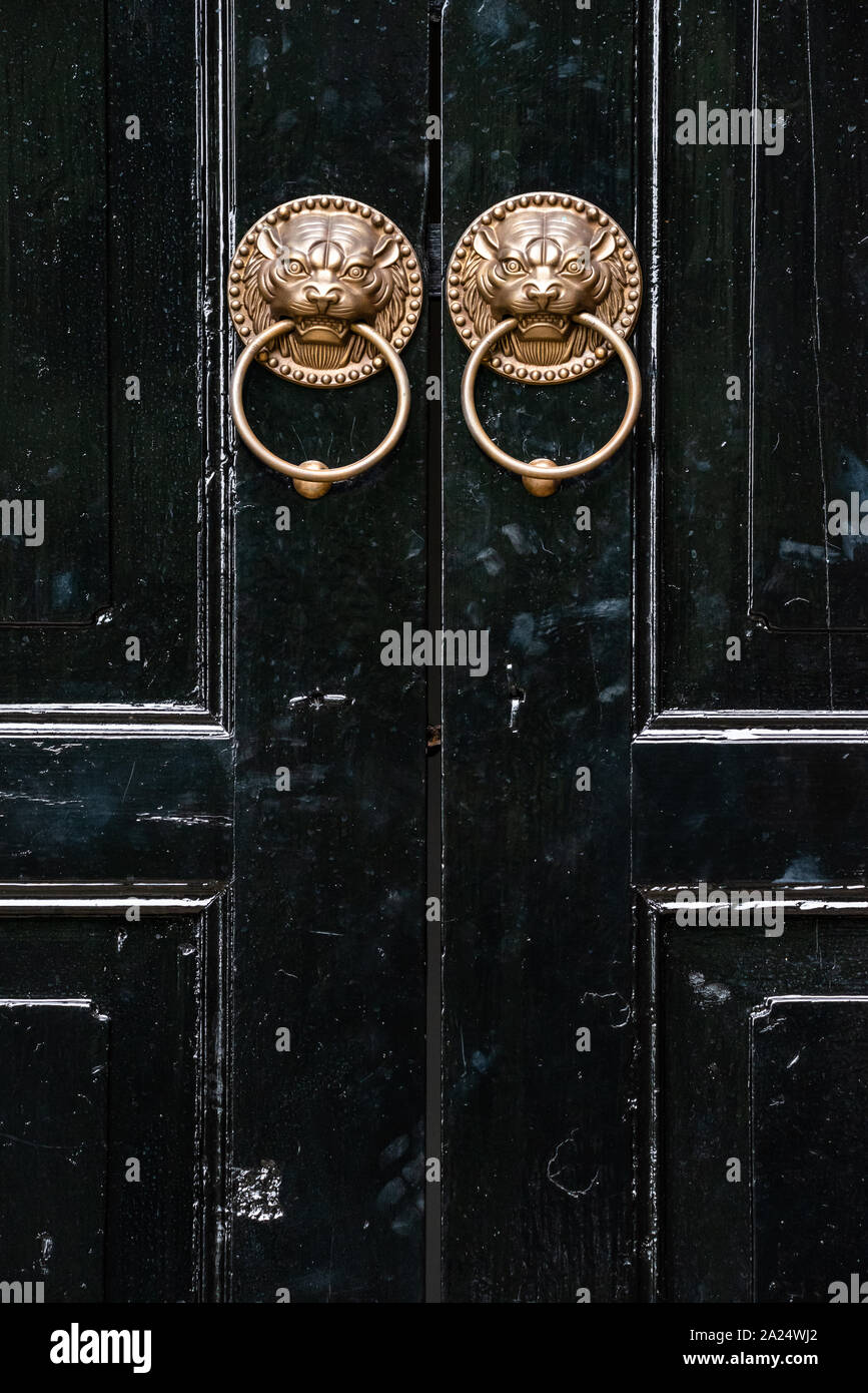 Lion chinese door knockers on a black door in China Stock Photo
