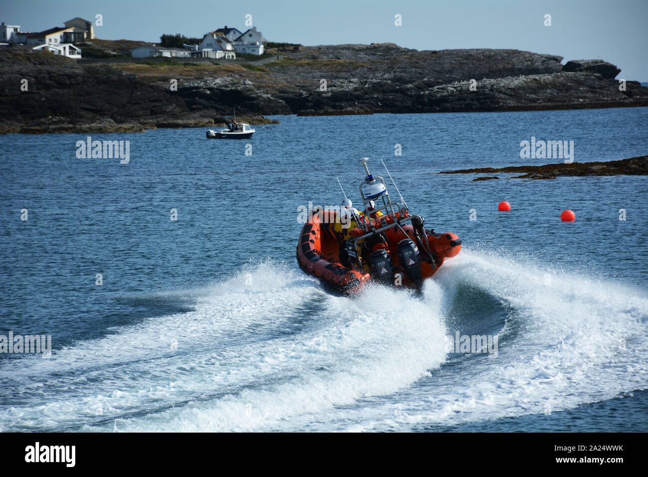 Trearddur bay Atlantic 85 and D class lifeboats launch on training exercise on a spring evening from the Trearddur bay lifeboat station on Anglesey. Stock Photo