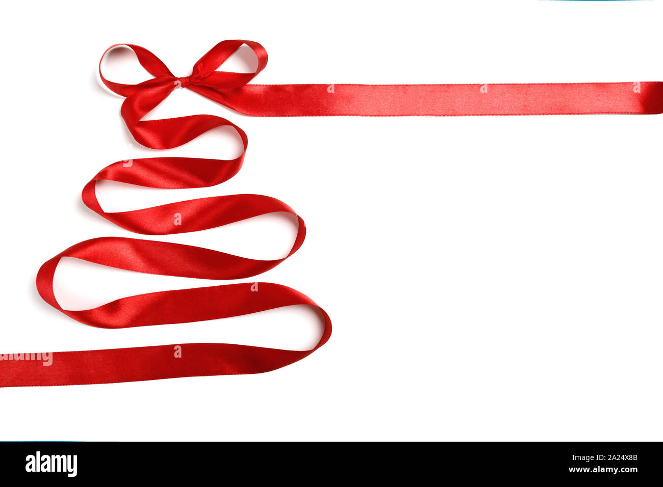 Christmas tree with a bow made of silk red ribbon isolated on white ...