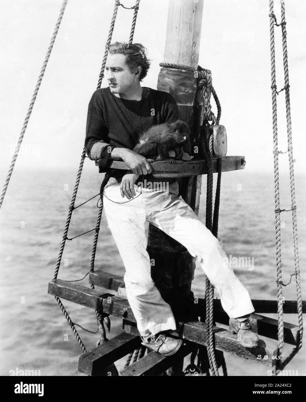 JOHN BARRYMORE young romantic portrait as Captain Ahab with his own pet monkey Clementine in THE SEA BEAST 1926 director Millard Webb loosely based on novel by Herman Melville silent movie Warner Bros. Stock Photo