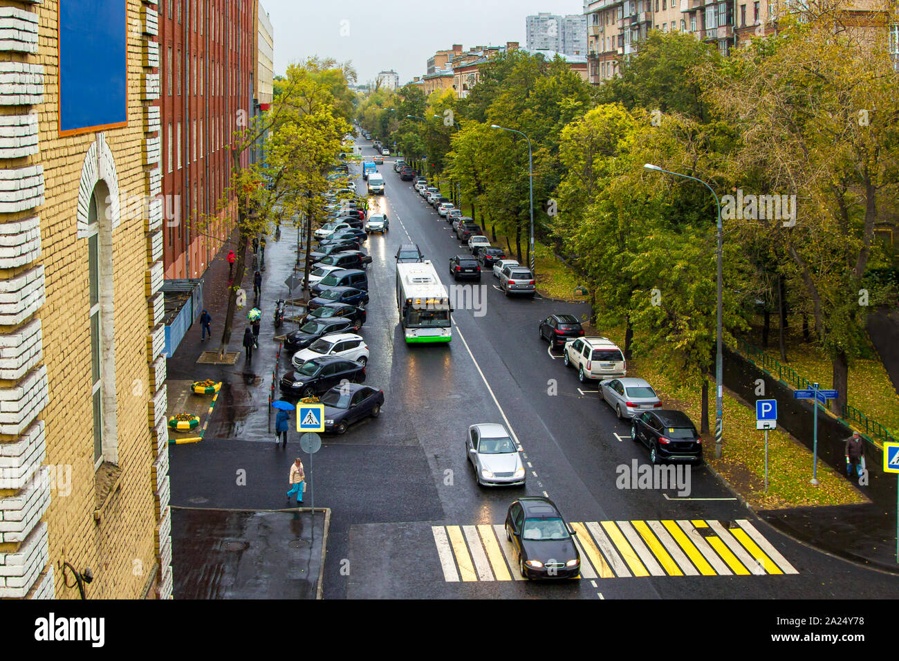 calm city street with cars and pedestrians in the rain Stock Photo - Alamy