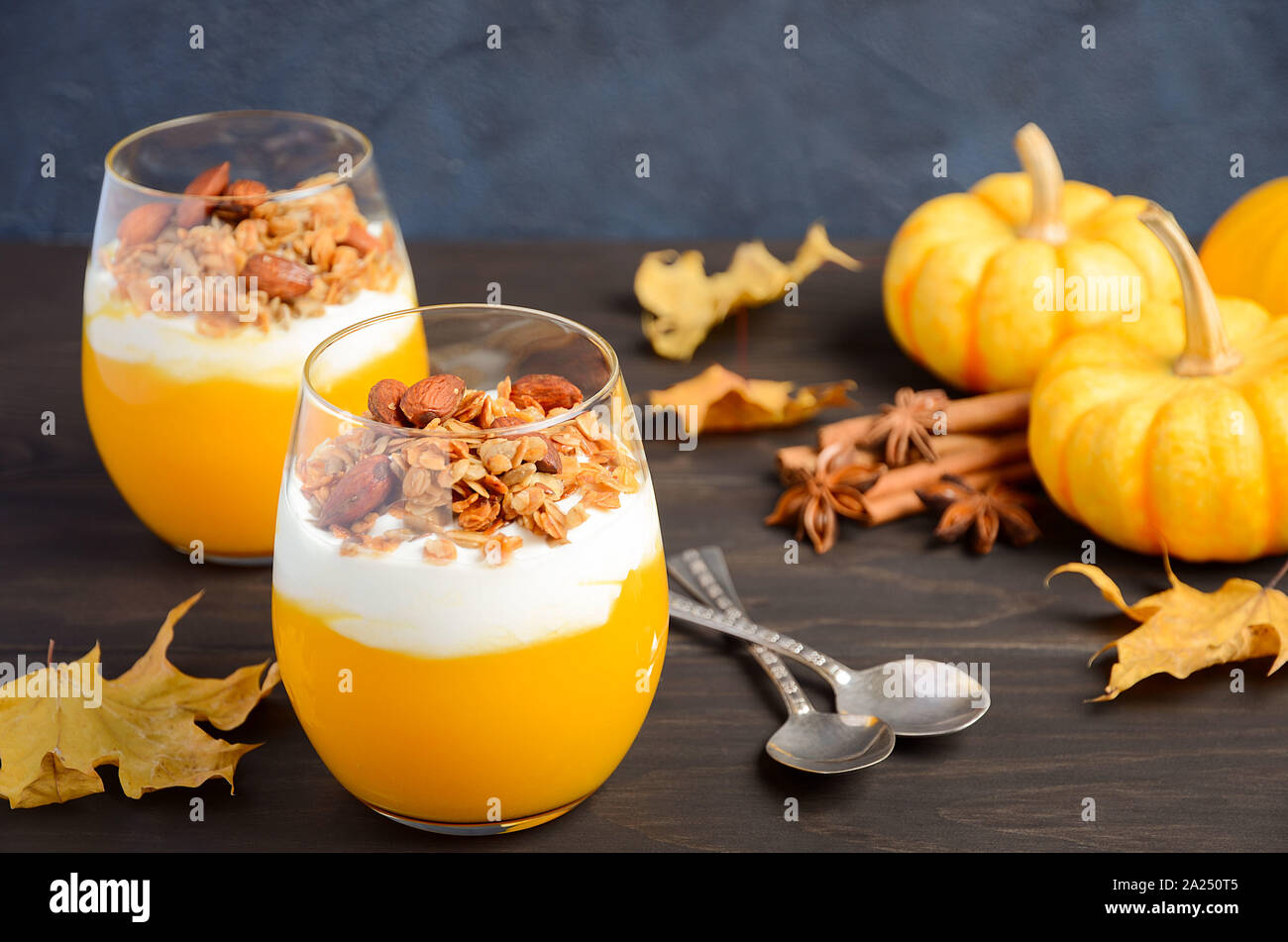 Pumpkin dessert with yogurt and homemade granola on dark wooden table. Stock Photo