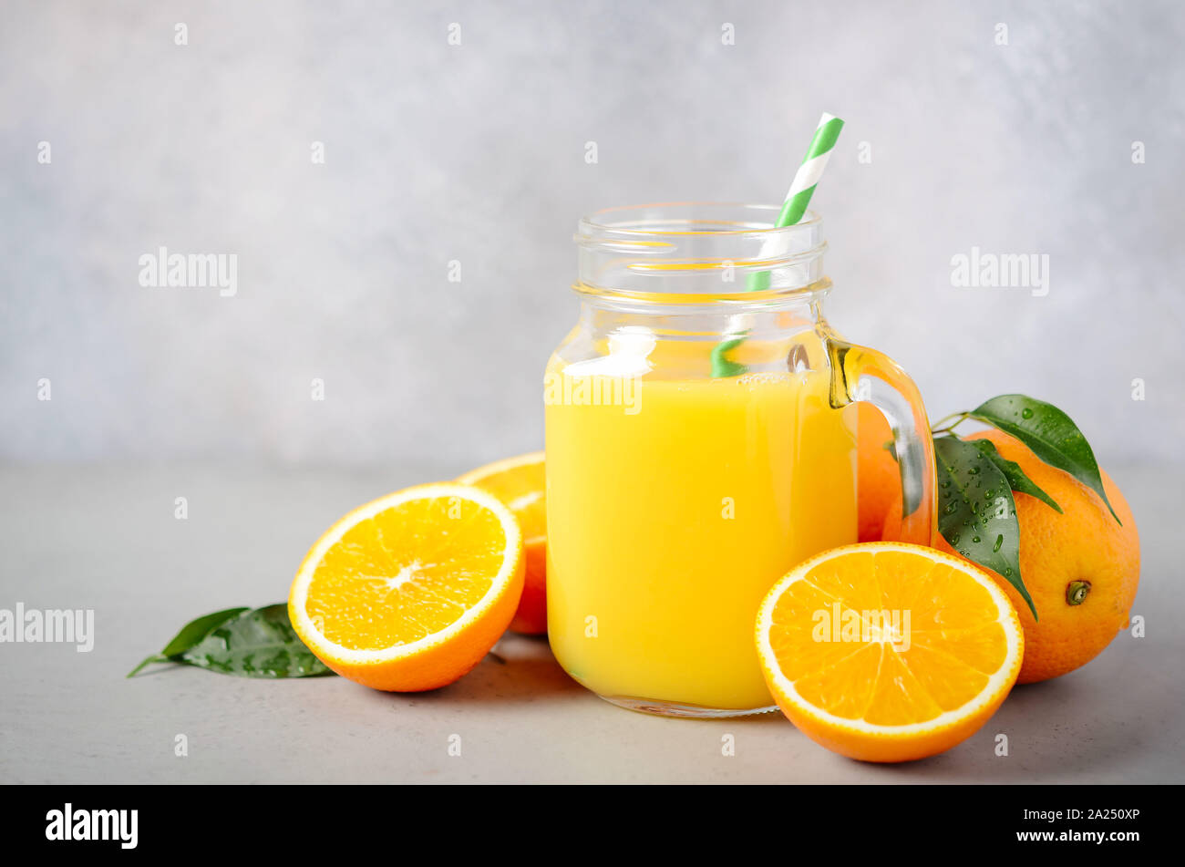 https://c8.alamy.com/comp/2A250XP/fresh-orange-juice-in-a-jar-on-gray-concrete-background-2A250XP.jpg