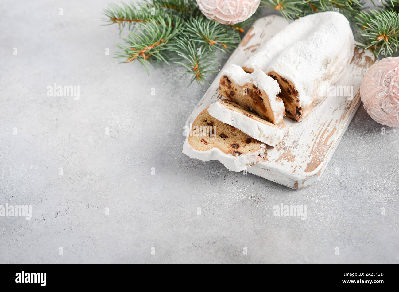 Christmas Stollen. Traditional German, European Festive Dessert. Holiday Concept Decorated with Fir Branches. Stock Photo