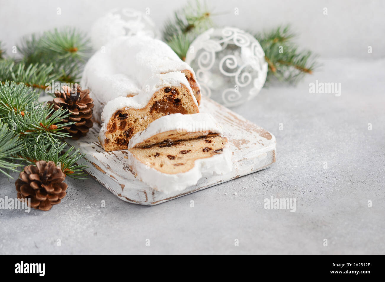 Christmas Stollen. Traditional German, European Festive Dessert. Holiday Concept Decorated with Fir Branches. Stock Photo