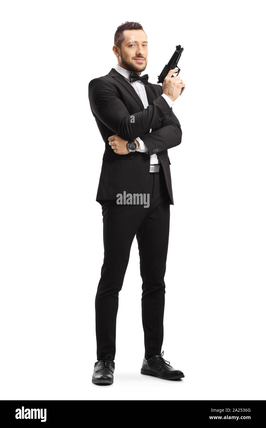 Full length portrait of a man in a suit holding a gun isolated on white background Stock Photo