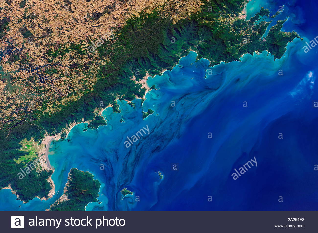 Phytoplankton bloom swirling in the waters off the coast of the Brazilian state of Sao Paulo. The Operational Land Imager (OLI) on the Landsat 8 satellite captured the image on September 5, 2017.  identified the species as likely to be Gymnodinium aureolum. Stock Photo