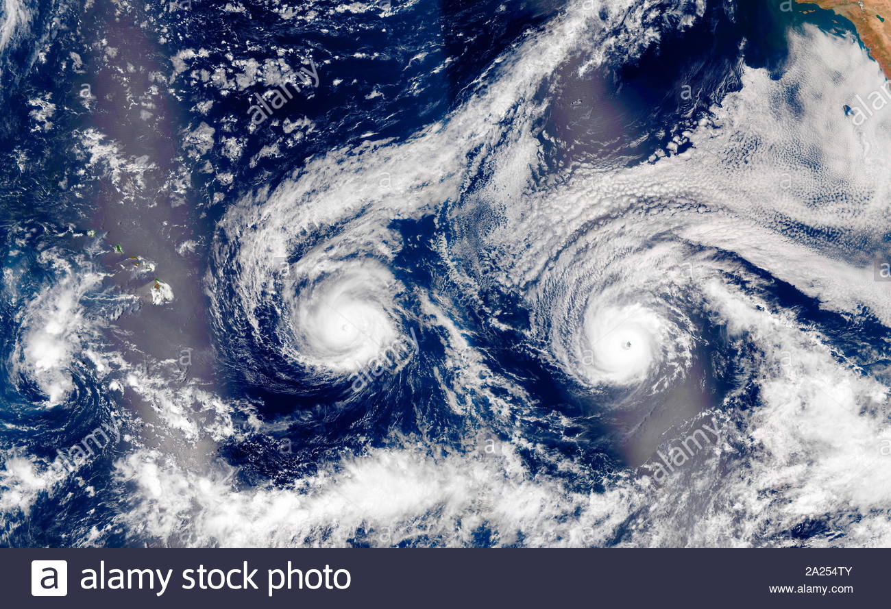 Hurricane Madeline and Hurricane Lester over Hawaii August 2016. The natural-colour image above is a composite built from two overpasses by the Visible Infrared Imaging Radiometer Suite (VIIRS) on the Suomi NPP satellite on August 29, 2016. At the time, Hurricane Madeline and Hurricane Lester were both hovering between category 3 and 4 storms. The bright streaks across the ocean surface (crossing Hawaii and Lester) are areas of sunlit, where sunlight reflected directly back at the VIIRS imager Stock Photo
