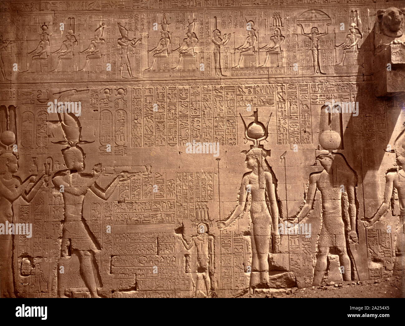 relief with hieroglyphics covers a wall in the Temple of Hathor, located in Dendera, Egypt. Dendera Temple complex. It is one of the best-preserved temple complexes in Egypt. The area was used as the sixth Nome of Upper Egypt, south of Abydos. Stock Photo