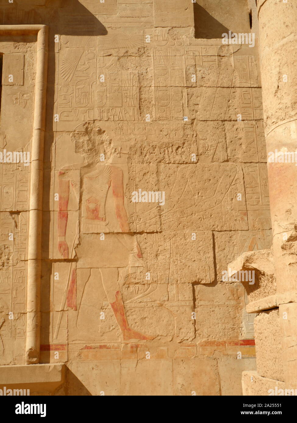 Defaced wall relief (painted) within the Temple of Hatshepsut, near Luxor, Egypt. The mortuary temple and tomb dates to the Eighteenth dynasty, and was designed by Senenmut, royal steward and architect of Hatshepsut. It was constructed during the 15th century BC, During the Eighteenth dynasty Stock Photo