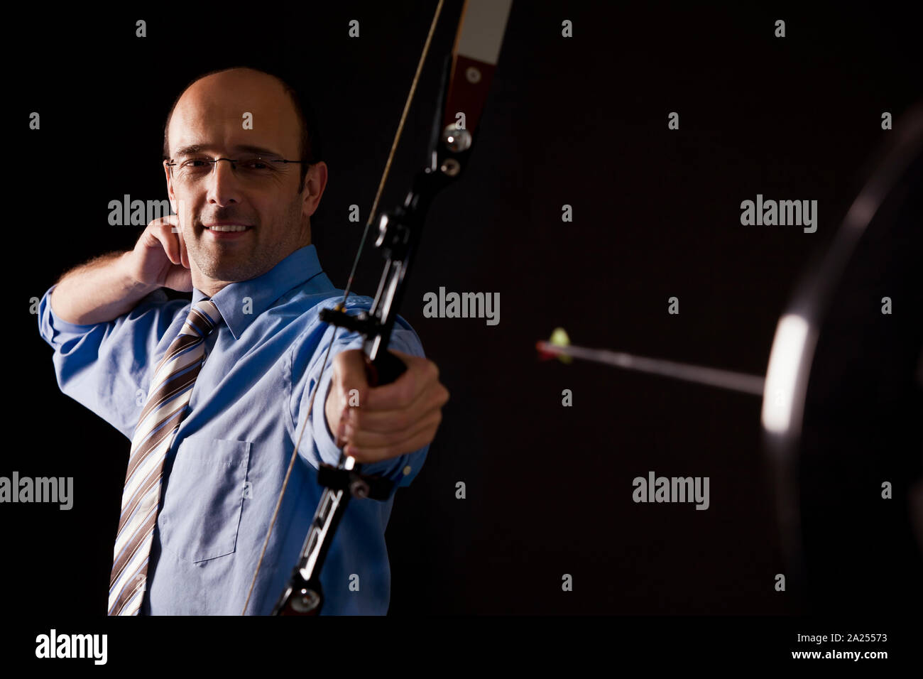 Business person hit target with arrow. Stock Photo