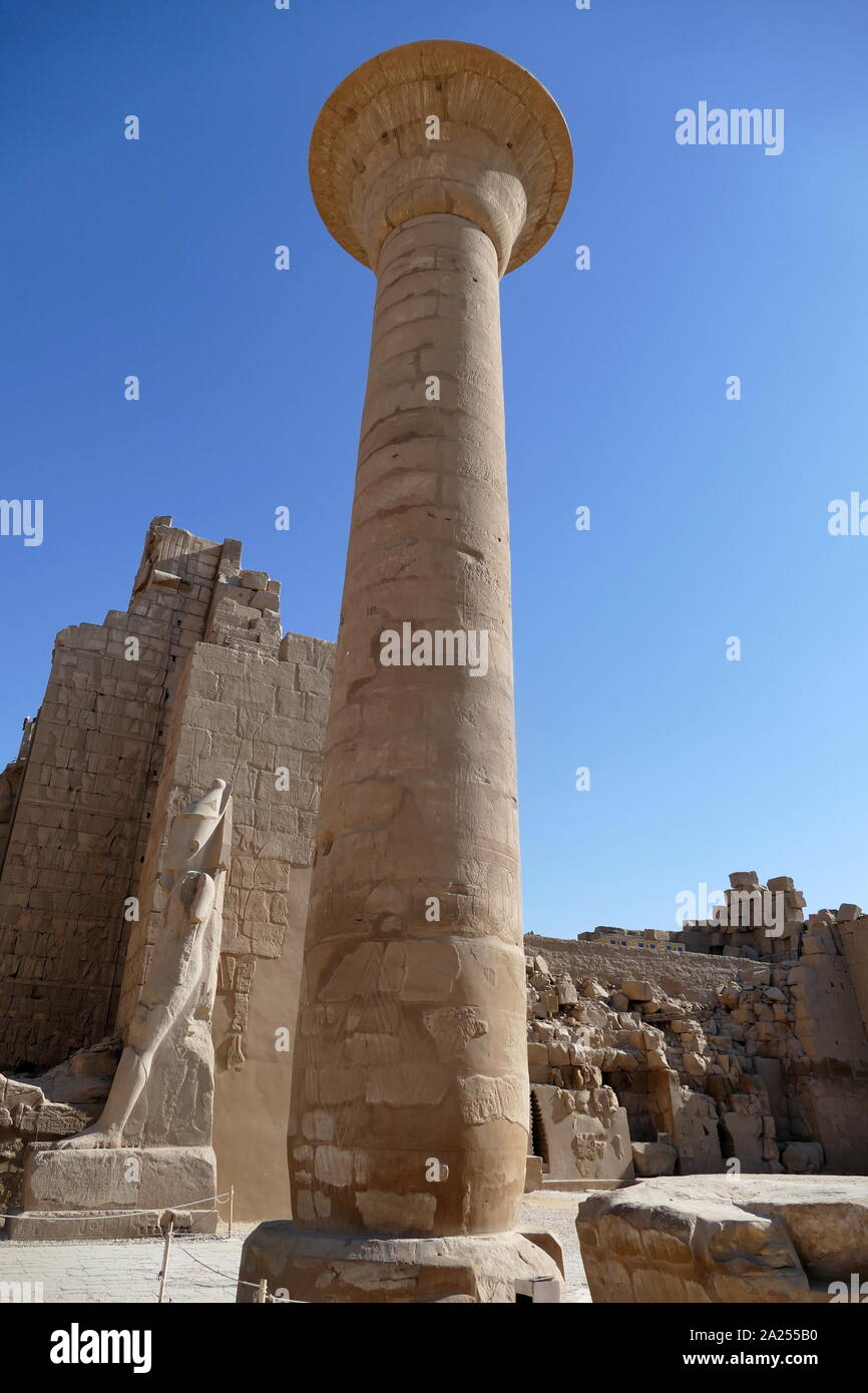 Hypostyle Hall at the Karnak Temple Complex, in Luxor, Egypt. Construction at the complex began during the reign of Senusret I in the Middle Kingdom and continued into the Ptolemaic period, although most of the extant buildings date from the New Kingdom. The area around Karnak was the main place of worship of the eighteenth dynasty Theban Triad with the god Amun as its head. It is part of the monumental city of Thebes. Stock Photo