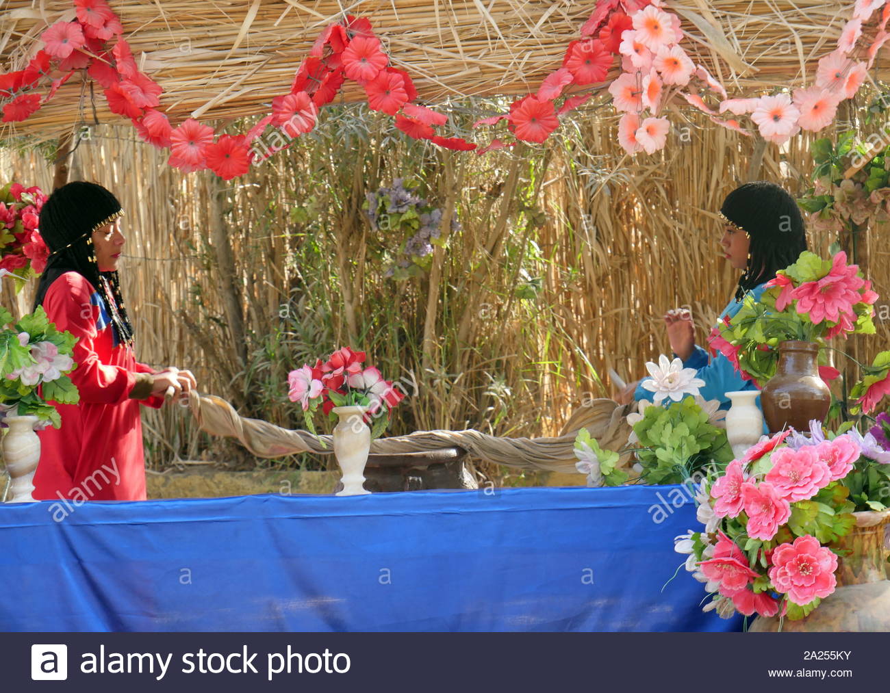 Reenactment of ancient Egyptian women preparing garlands of flowers Stock Photo Alamy