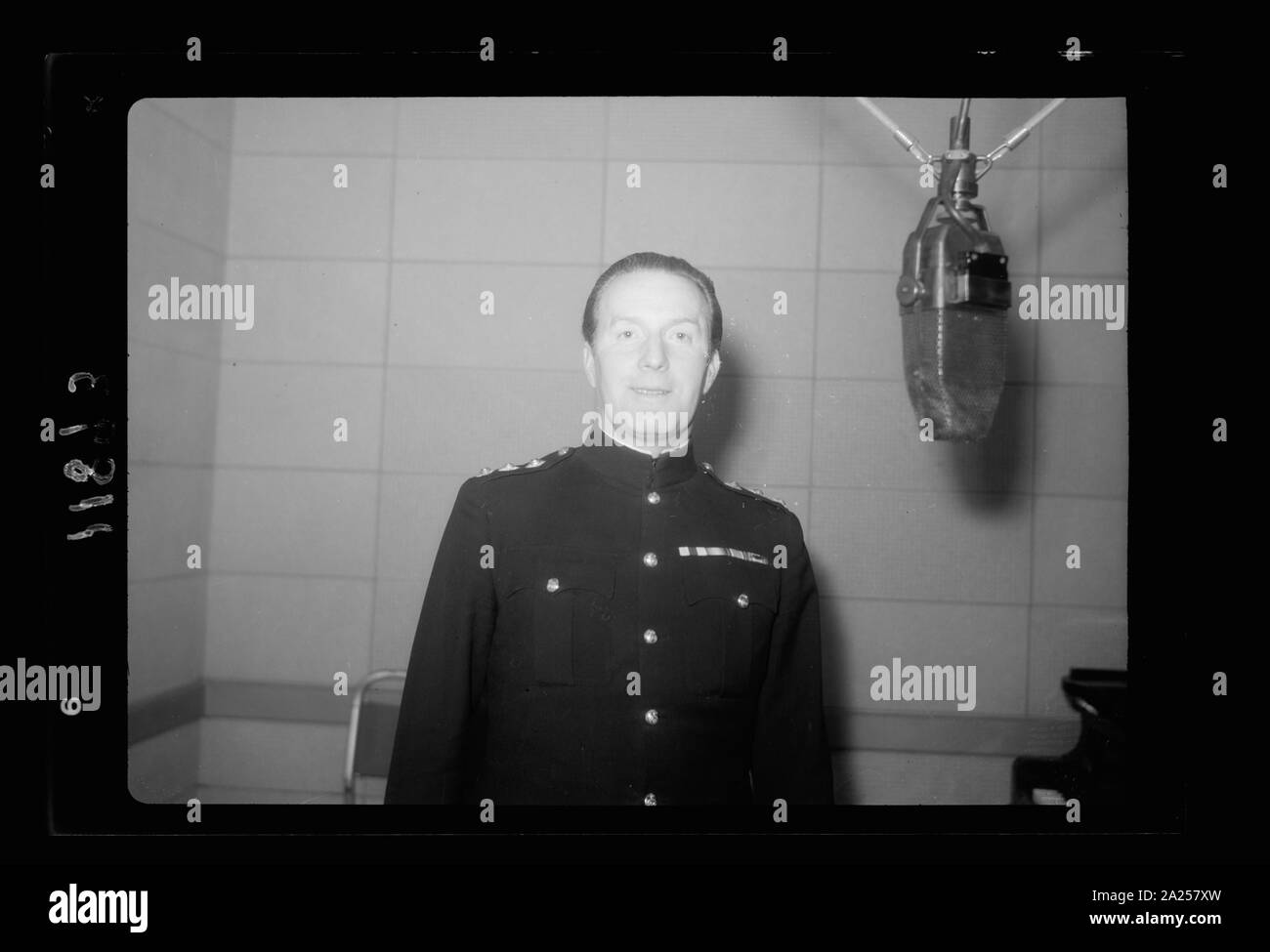 Photo taken in Palestine Broadcasting Service Studios, Jerusalem. Captain Lance Fairfax at mic. i.e., microphone, Lt. Watson at piano, close up Stock Photo