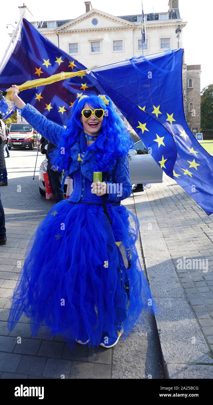 Pro-Remain Brexit campaigner wearing EU colours and holding EU Flag, outside Parliament in London, April 2019.Brexit is the process of the withdrawal of the United Kingdom (UK) from the European Union (EU). Following a referendum held on 23 June 2016 in which 51.9 per cent of those voting supported leaving the EU Stock Photo
