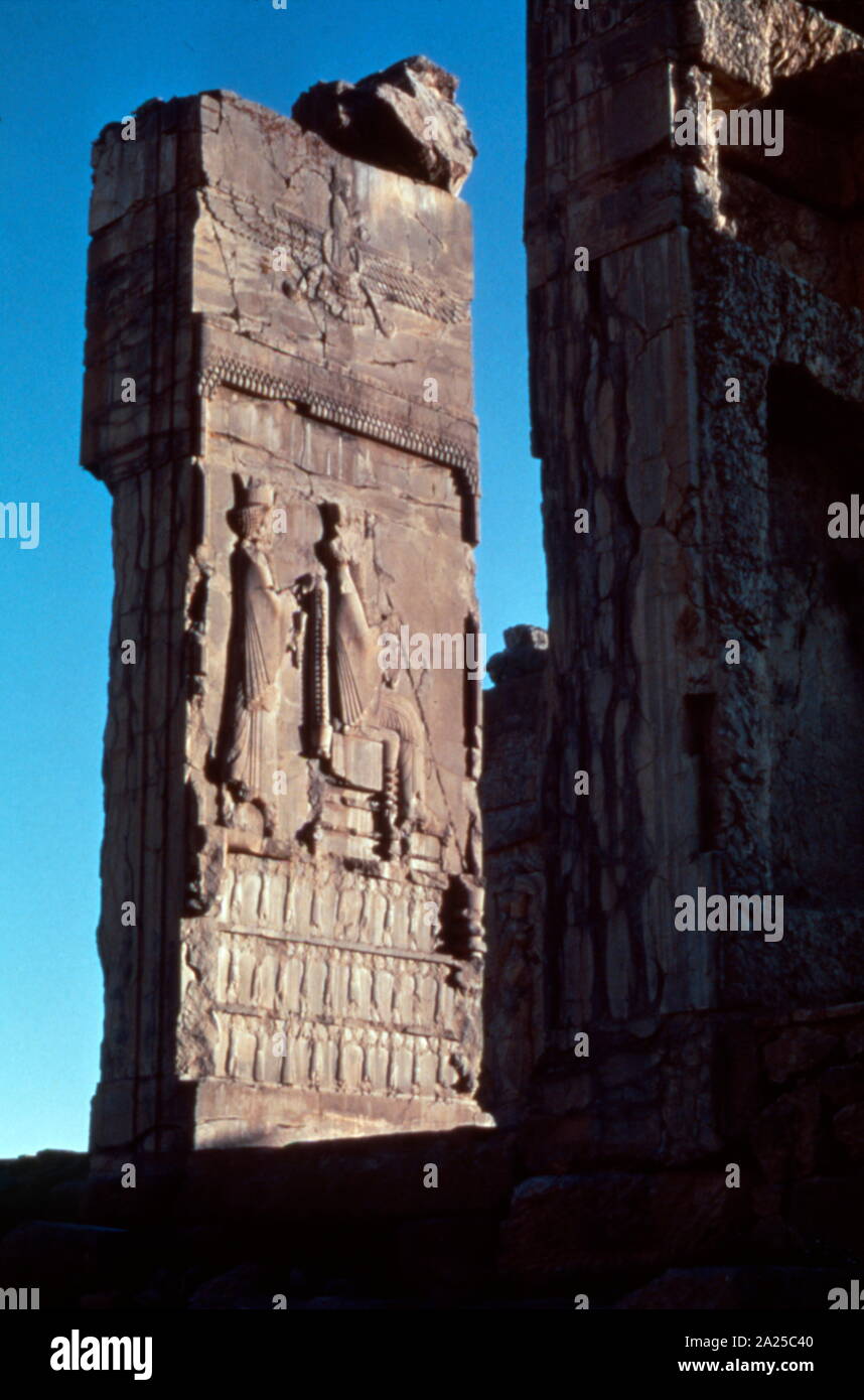 Doorway to the Hall of one hundred columns, Palace of Persepolis, Iran. Depicting Sargon Ist seated. 500 BC Stock Photo