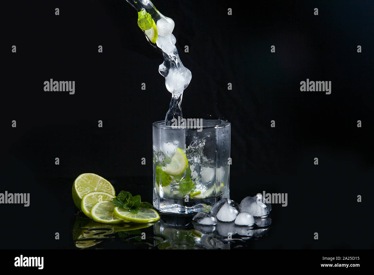 Mojito Summer Beach Refreshing Tropical Cocktail In Glass With Splash Soda Water Lime Juice Mint Leaves Sugar Ice And Rum On Reflective Black Surf Stock Photo Alamy