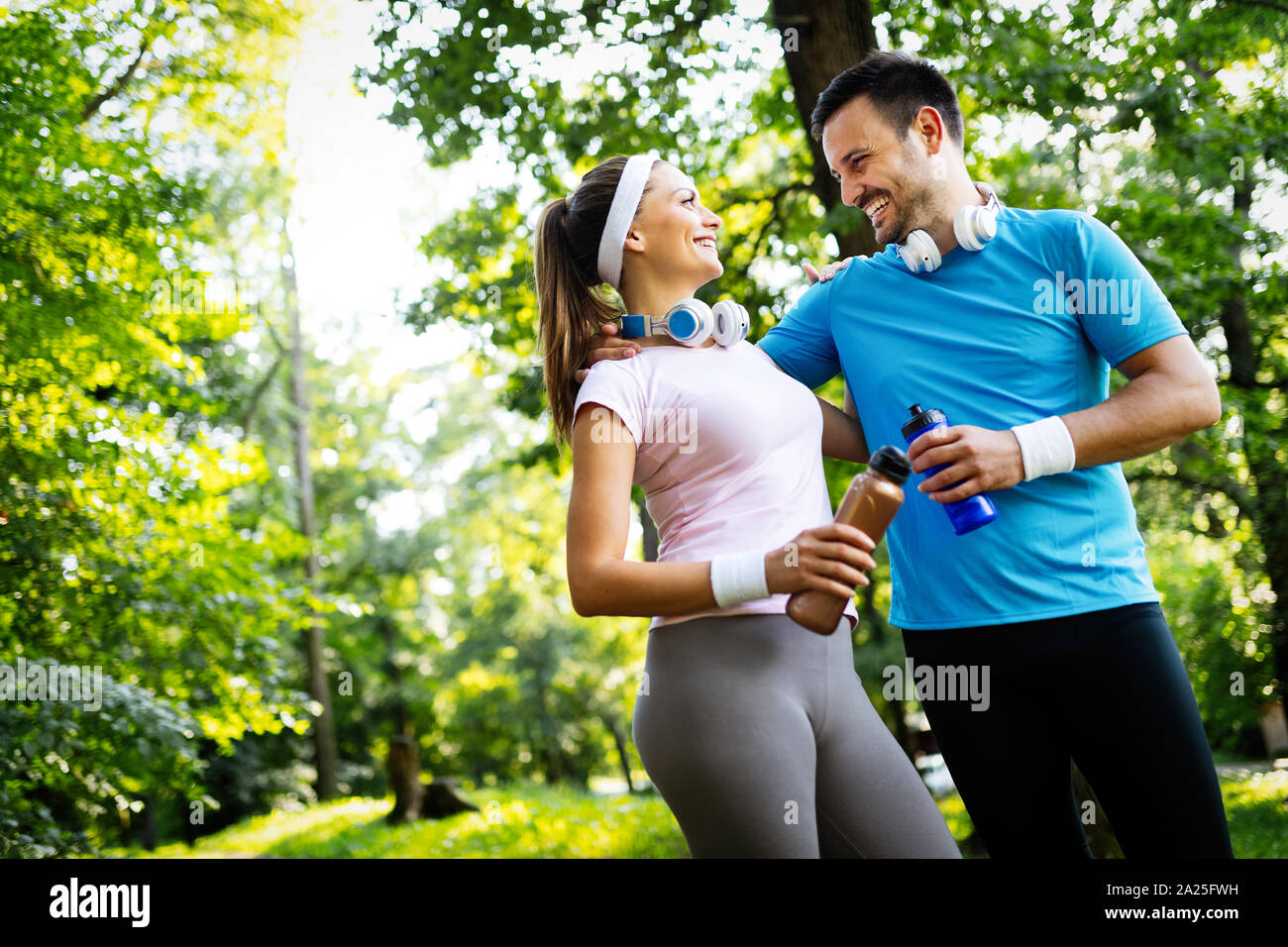 Happy couple running and exercising together outdoor Stock Photo - Alamy