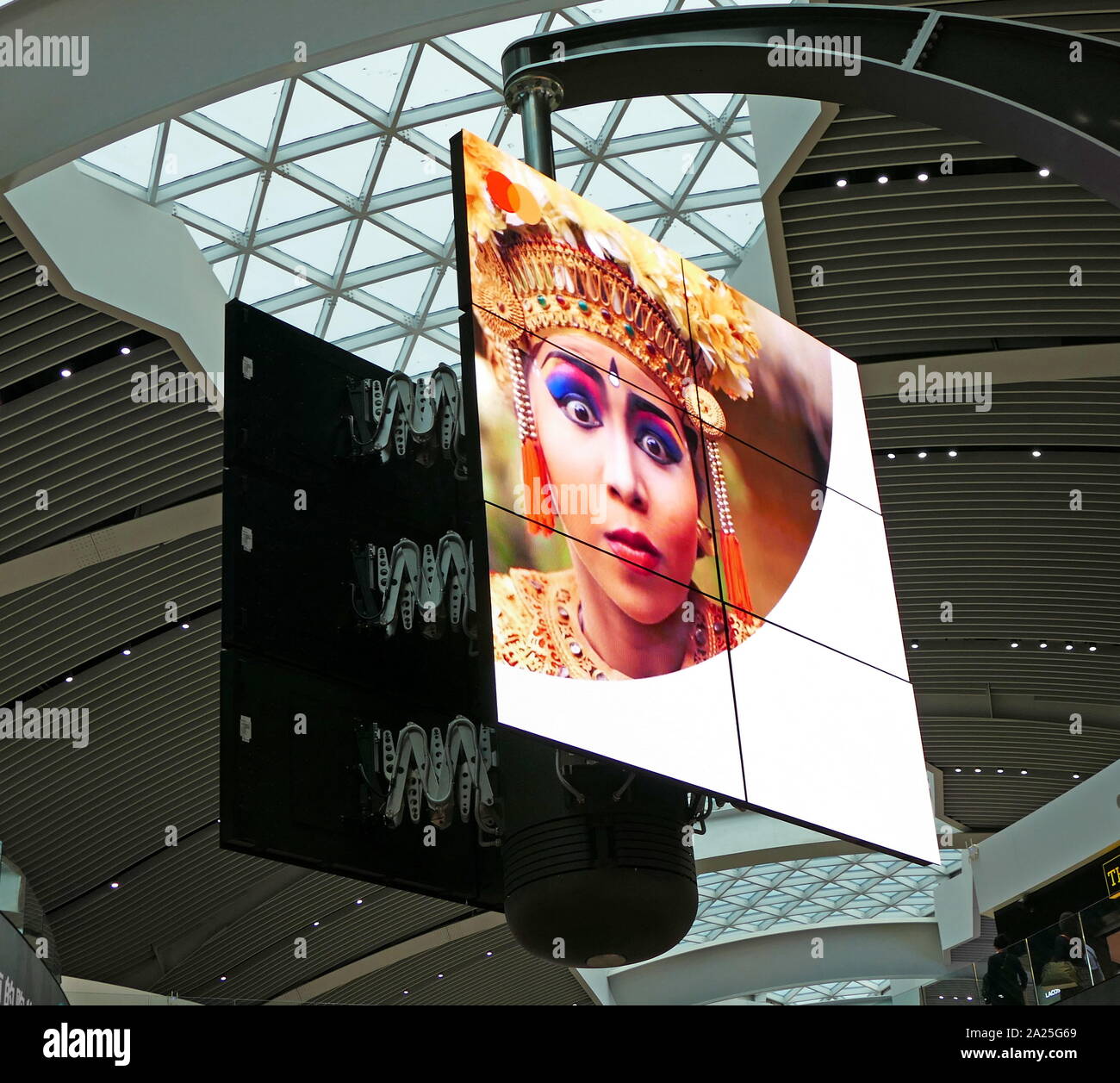 A bank of digital television screens in the departures terminal of Rome–Fiumicino International Airport . The screens display sequential adverts on a regular cycle in which both adverts and screens rotate shift and re-align to create multiple or grouped images. Stock Photo