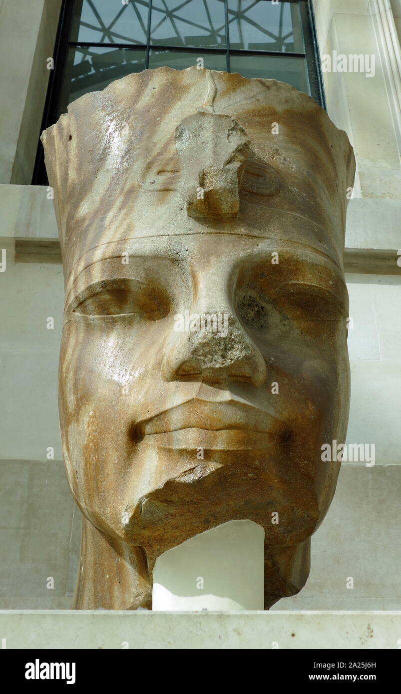 Quartzite colossal head of the Egyptian Pharaoh, Amenhotep III; 18th Dynasty; 1400 BC. The king wears the red crown of Lower Egypt. Found at Thebes Stock Photo