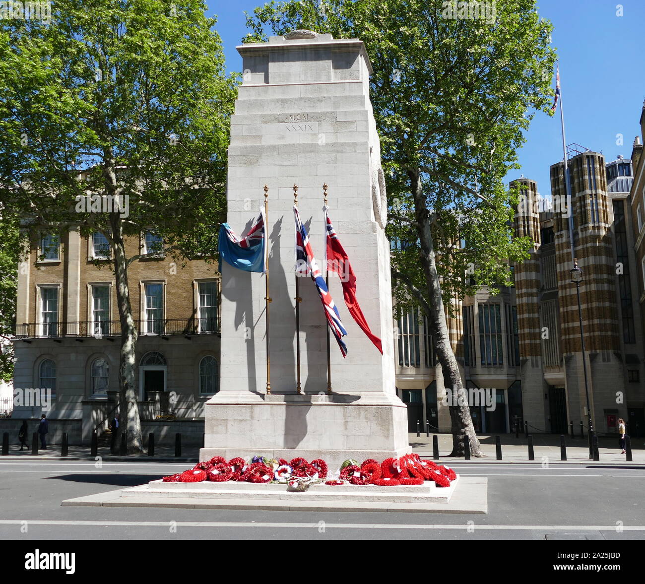 The Cenotaph war memorial on Whitehall in London, England. Its origin is in a temporary structure erected for a peace parade following the end of the First World War, and after an outpouring of national sentiment it was replaced in 1920 by a permanent structure and designated the United Kingdom's official national war memorial. Designed by Edwin Lutyens, the permanent structure was built from Portland stone between 1919 and 1920 Stock Photo
