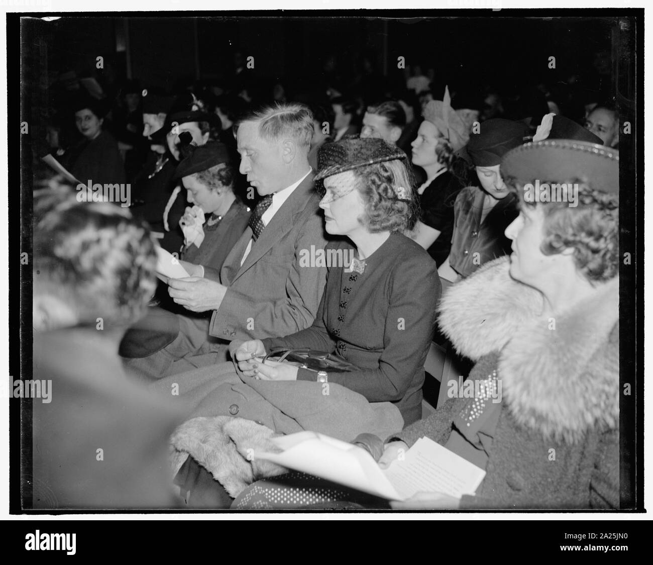 Picture of a Supreme Court Justice whistling 'Jingle Bells.' Washington, D.C., Dec. 20. During the 8th Annual broadcasting of the Children of Diplomats stationed here in Washington, Supreme Court Justice William O. Douglas, and his wife, sat with other mothers and fathers watching their offspring say 'Merry Christmas' in their native tongues. During an intermission, the Marine Band played 'Jingle Bells' and above the music of the band could be heard Justice Douglas whistling Stock Photo