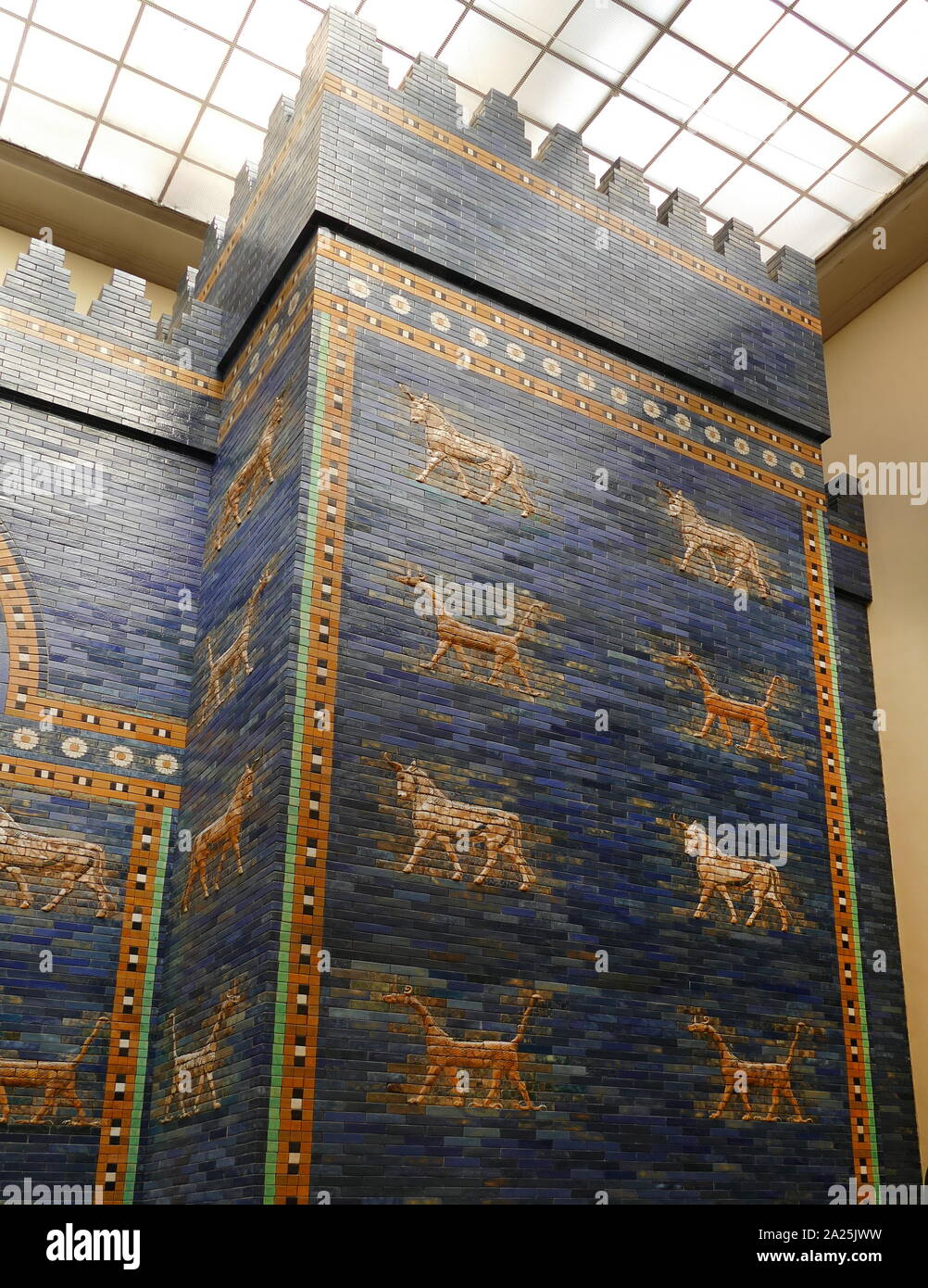 The Ishtar Gate of Babylon. constructed in about 575 BC, by order of King Nebuchadnezzar II on the north side of the city. It was part of a grand walled processional way leading into the city. The walls were finished in glazed bricks mostly in blue, with animals and deities in low relief at intervals, these also made up of bricks that are moulded and colored differently. It was excavated in the early 20th century, and a reconstruction using original bricks, completed in 1930, is now shown in Berlin’s Pergamon Museum. Stock Photo