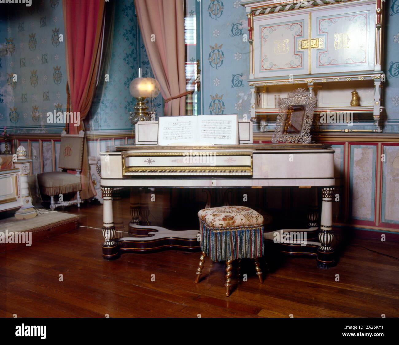 19th century Ivory covered piano in a salon of the Château de  Roquetaillade; a castle in Mazères (near Bordeaux), France. The  extraordinary interior decorations, with its furnishings and paintings,  were created by