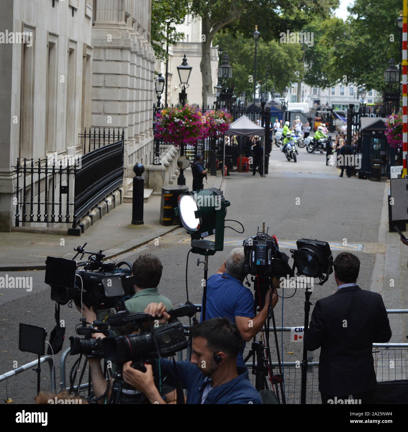 Press gathered in downing street, london, for the arrival of incoming new prime minister, boris johnson. downing street is the official residences and offices of the prime minister of the united kingdom and the chancellor of the exchequer. situated off whitehall, a few minutes' walk from the houses of parliament, downing street was built in the 1680s by sir george downing. Stock Photo