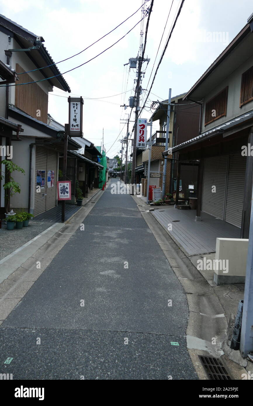 Merchants houses, Nara, Japan. Machiya are urban houses that once housed the merchant class and artisans of the cities of Japan. So, a house was often a shop, workshop and residence at the same time. Made entirely of wood, they were prey to successive fires and earthquakes. Stock Photo