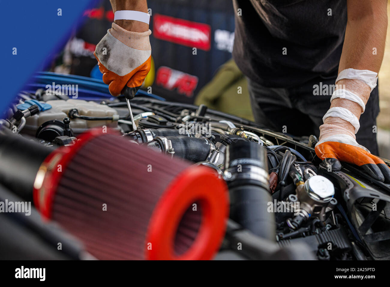 Automobile mechanic repairing a car engine. man fixing the engine car. service and maintenance. Stock Photo