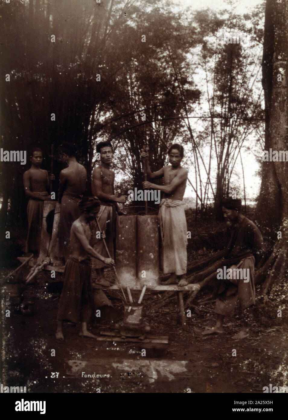 Colonial era photograph of Vietnamese foundry workers; 1895 Stock Photo