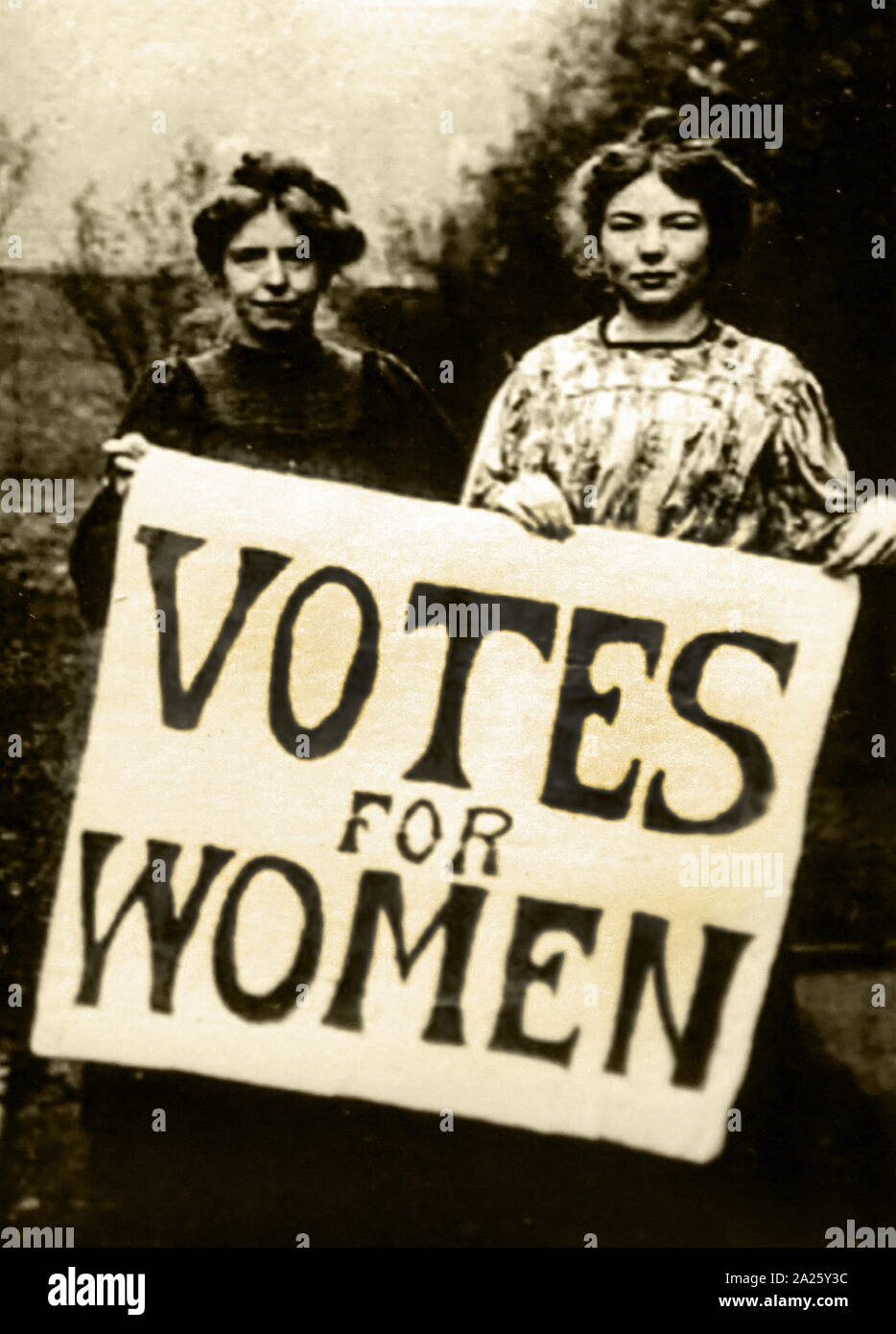 Photograph of suffragettes protesting in Britain. A suffragette was a member of militant women's organisations in the early 20th century who, under the banner "Votes for Women", fought for the right to vote in public elections, known as women's suffrage. Stock Photo