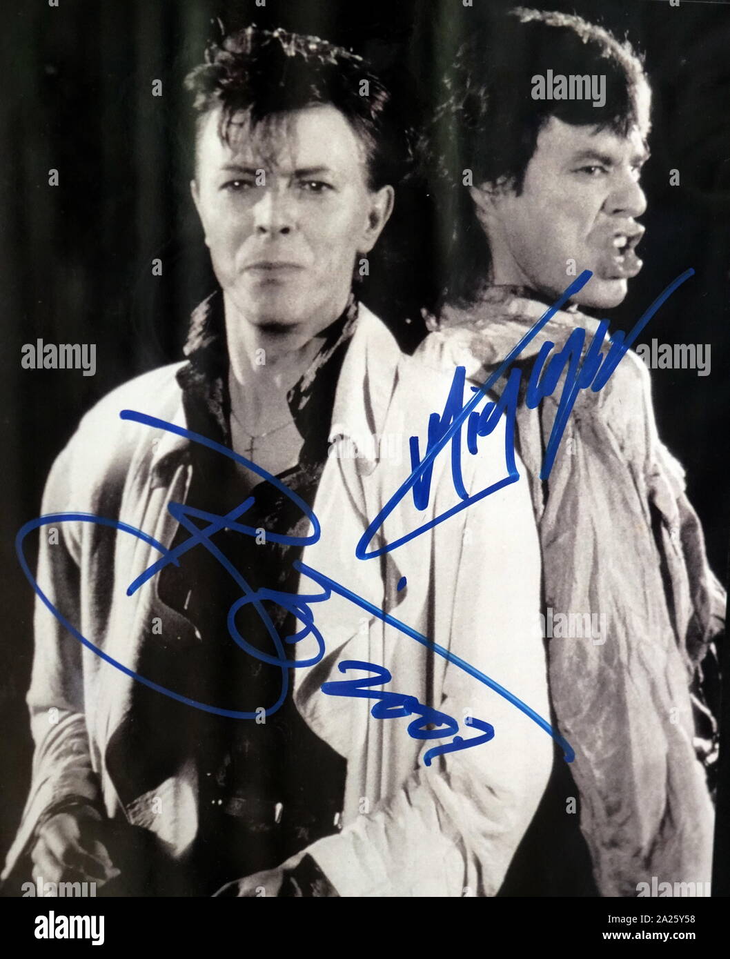 Signed photograph of David Bowie and Mick Jagger. David Robert Jones (1947-2016) an English singer, songwriter, and actor. Sir Michael Philip Jagger (1943-) an English singer, songwriter, actor and film producer. Stock Photo