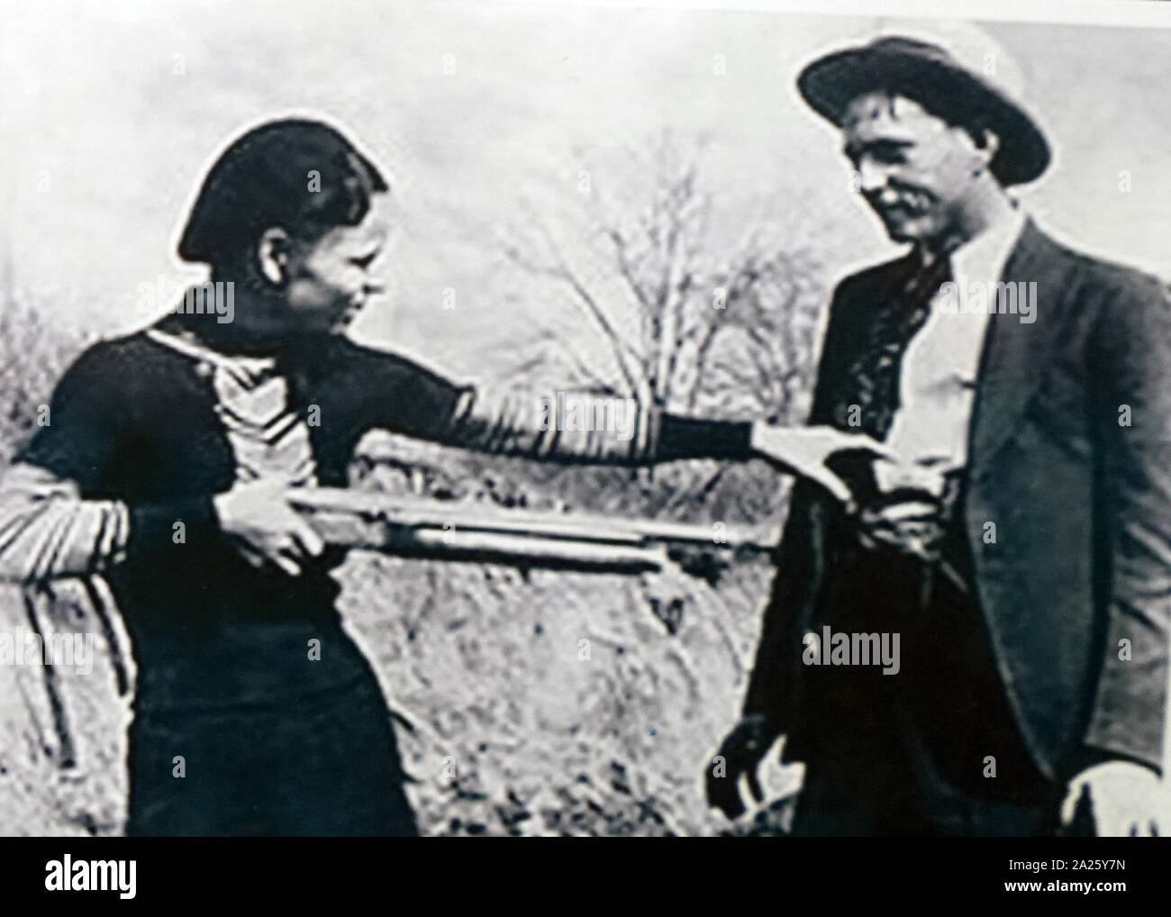 A photograph of Bonnie and Clyde. Bonnie Elizabeth Parker (1910-1934) and Clyde Chestnut Barrow (1909-1934) American criminals who travelled around the Central United States with their gang during the Great Depression. Stock Photo