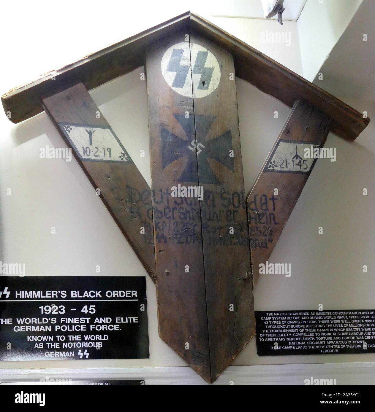 A wooden burial marker for a German SS soldier. The SS was a major paramilitary organization under Adolf Hitler and the Nazi Party. Stock Photo