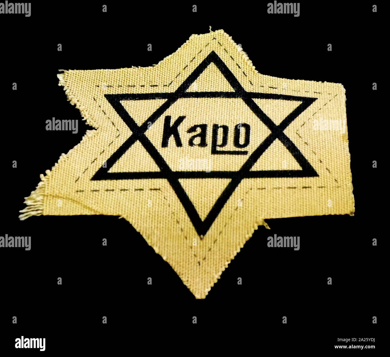 A yellow star worn by kapo in concentration camps. A kapo or prisoner functionary was a prisoner assigned by SS guards to supervise forced labour or carry out administrative tasks. Stock Photo