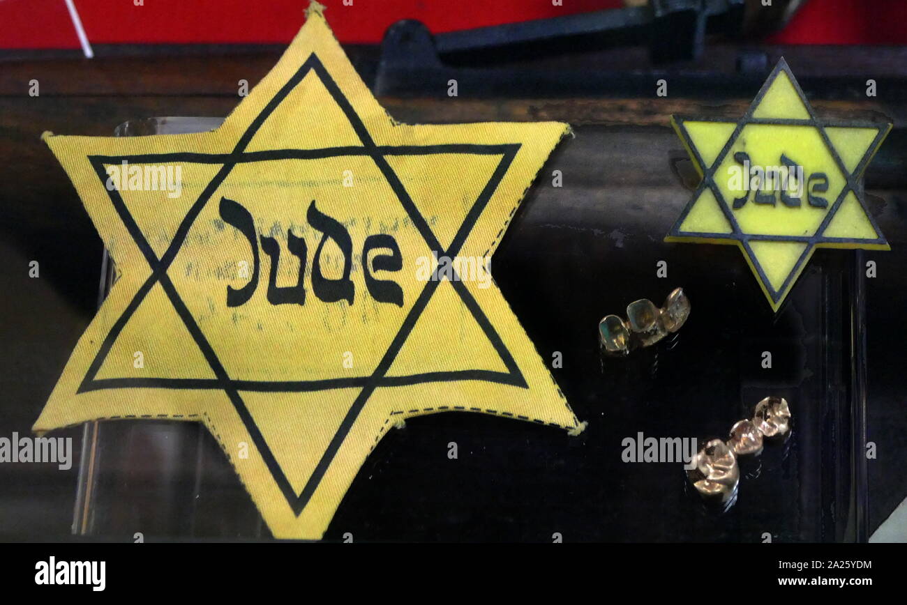 A collection of items belonging to holocaust victims including yellow stars and gold fillings. Stock Photo