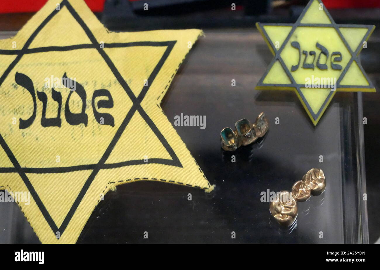 A collection of items belonging to holocaust victims including yellow stars and gold fillings. Stock Photo