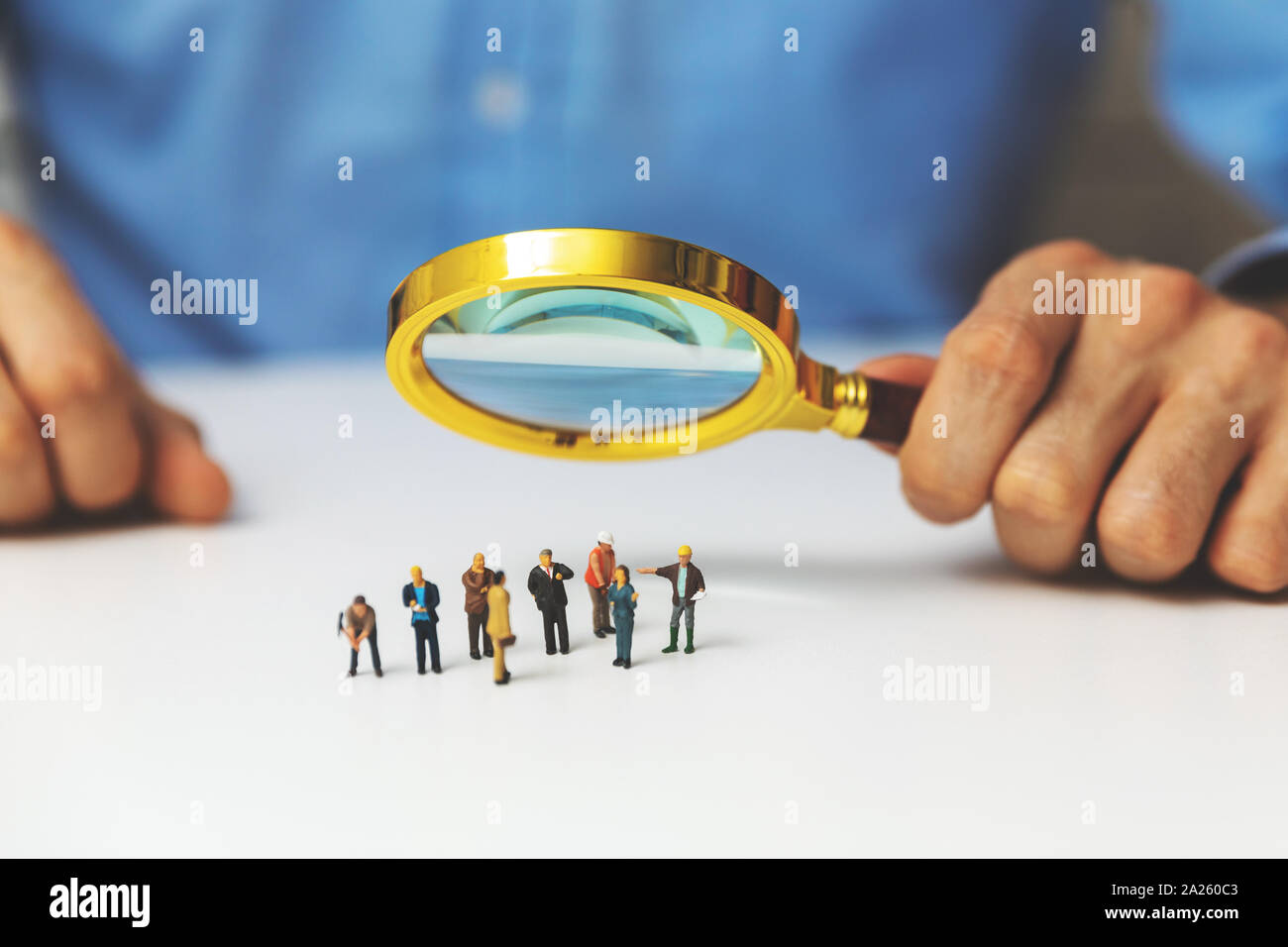 employee search staff selection concept - recruitment manager with magnifying glass Stock Photo