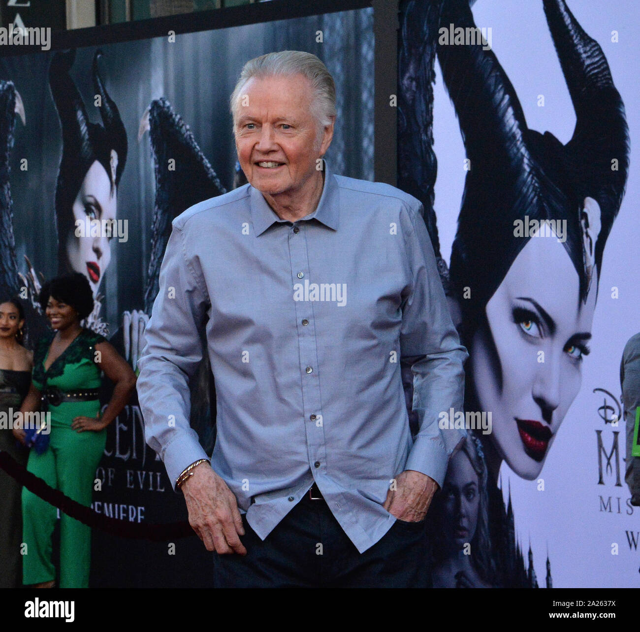 Los Angeles, United States. 30th Sept, 2019. Actor Jon Voight, father of cast member Angelina Jolie, pictured on the movie poster at rear, attends the premiere of the motion picture fantasy 'Maleficent: Mistress of Evil' at the El Capitan Theatre in the Hollywood section of Los Angeles on Monday, September 30, 2019. Storyline: Maleficent and her goddaughter Aurora begin to question the complex family ties that bind them as they are pulled in different directions by impending nuptials, unexpected allies, and dark new forces at play. Photo by Jim Ruymen/UPI Credit: UPI/Alamy Live News Stock Photo