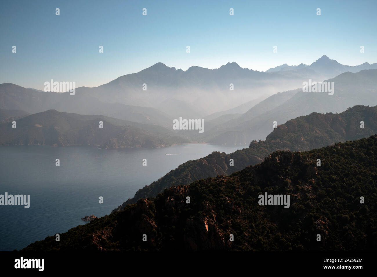 The distant mountains and sea landscape of the Gulf of Porto viewed from Piana in western Corsica Stock Photo