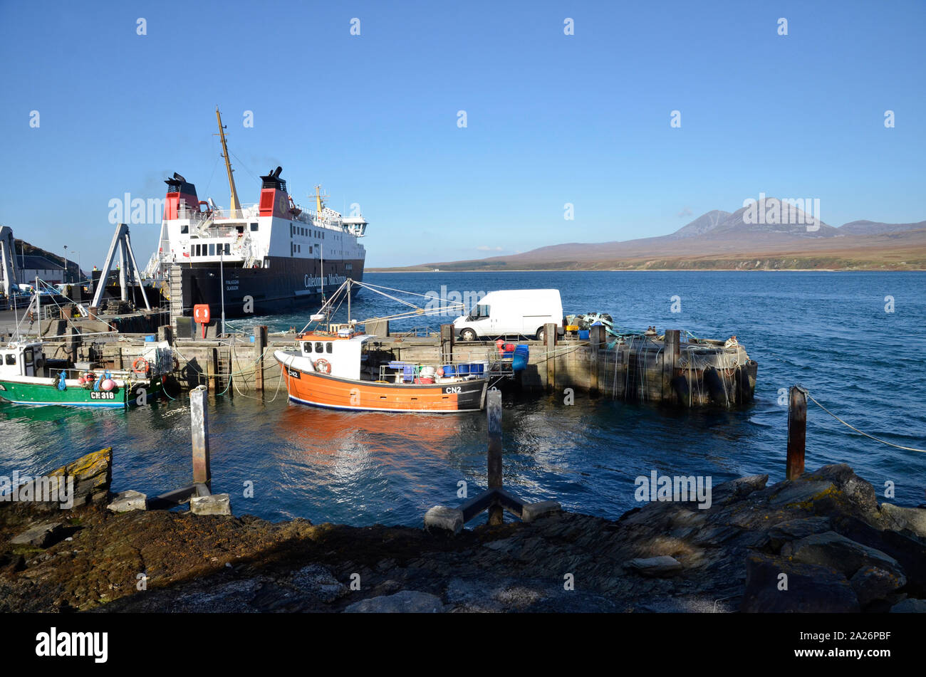 MV Finlaggan, Caledonian MacBrayne island ferry at Port Askaig on the Scottish Island of Islay. The Paps of Jura hills can be seen in the background. Stock Photo