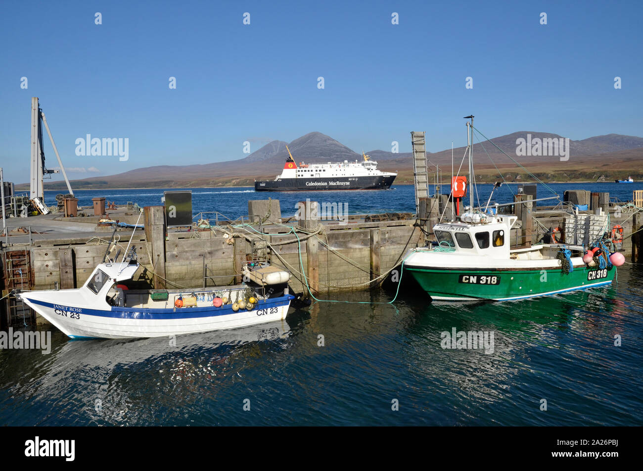 MV Finlaggan, a Caledonian MacBrayne island ferry at Port Askaig on the Scottish Island of Islay. The Paps of Jura can be seen in the background. Stock Photo