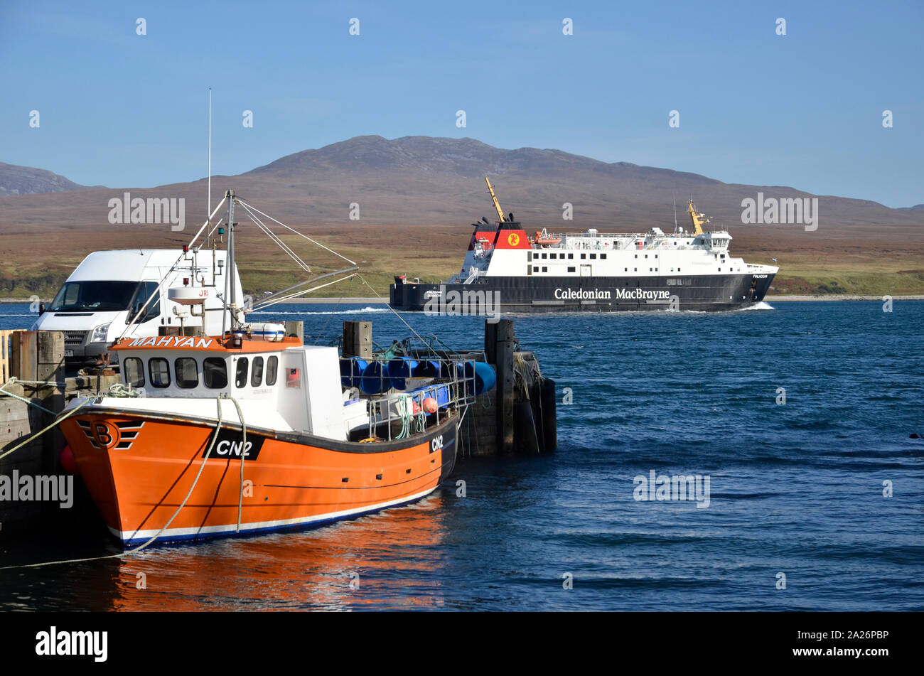 MV Finlaggan, a Caledonian MacBrayne island ferry at Port Askaig on the Scottish Island of Islay. The hills of Jura can be seen in the background. Stock Photo
