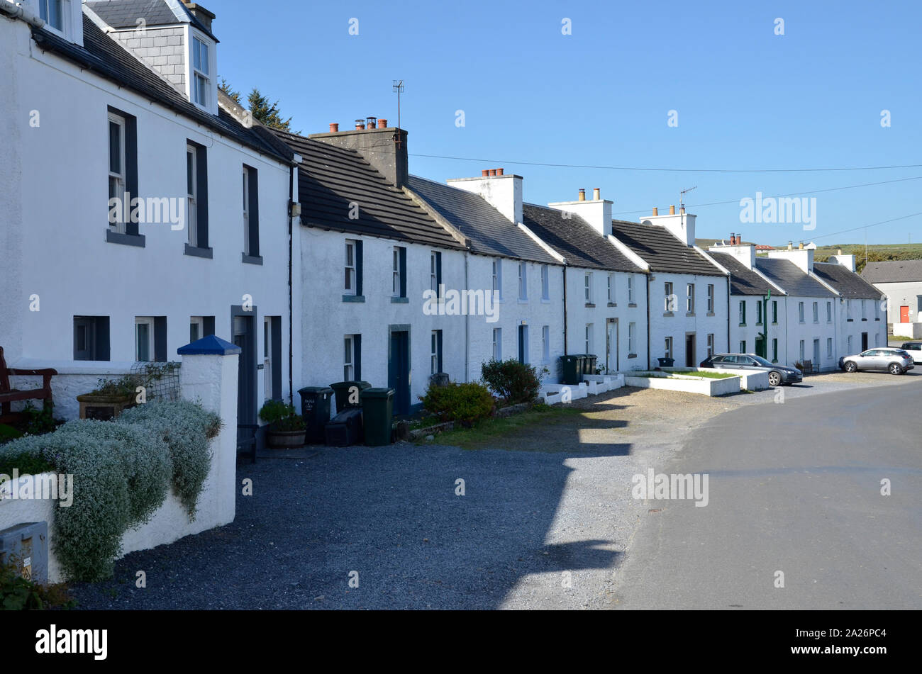 White-painted houses in the village of Port Charlotte, one of the settlements on the Scottish Isle of Islay. Stock Photo